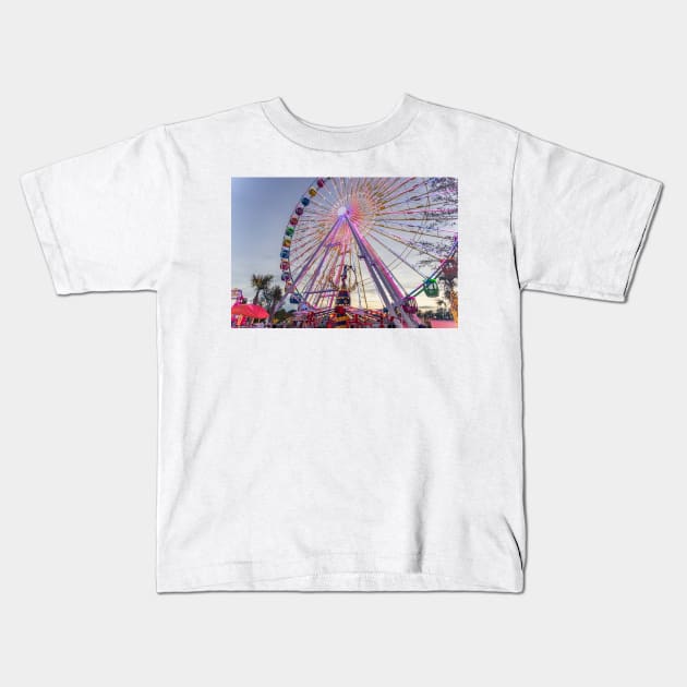 Ferris Whee at dusk Kids T-Shirt by KensLensDesigns